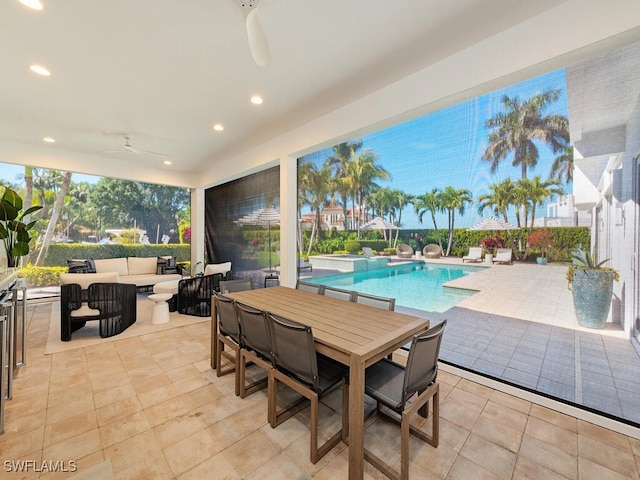 view of patio / terrace with an outdoor living space, outdoor dining space, a ceiling fan, and a pool with connected hot tub