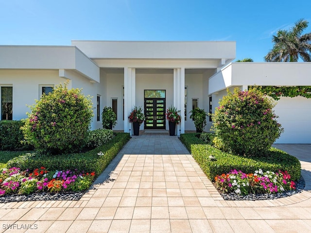 entrance to property featuring stucco siding