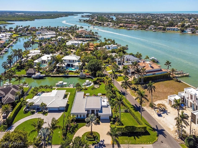 drone / aerial view featuring a water view and a residential view