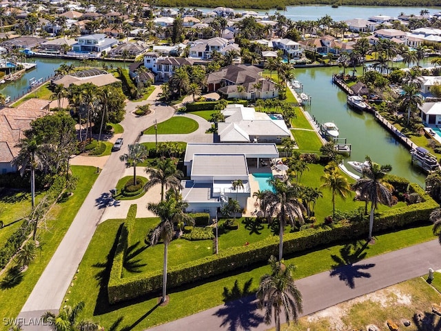 birds eye view of property featuring a residential view and a water view