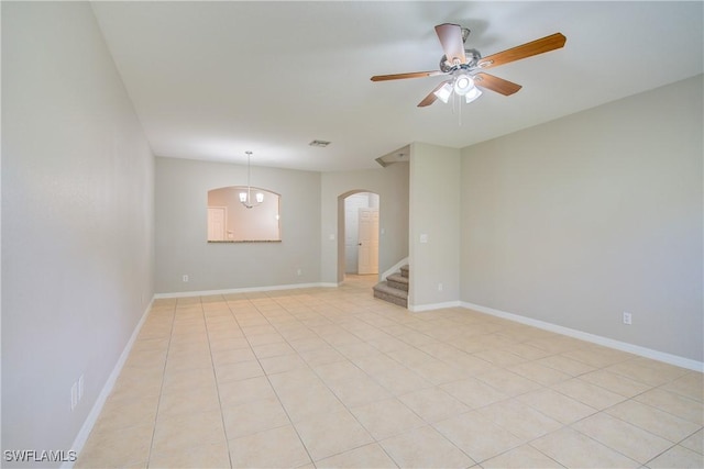17545 Cherry Ridge Ln, Fort Myers, FL 33967 - unfurnished room featuring arched walkways, ceiling fan, visible vents, baseboards, and stairway
