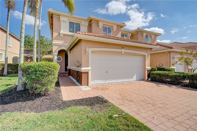 17545 Cherry Ridge Ln, Fort Myers, FL 33967 - mediterranean / spanish-style home with decorative driveway, a tiled roof, an attached garage, and stucco siding