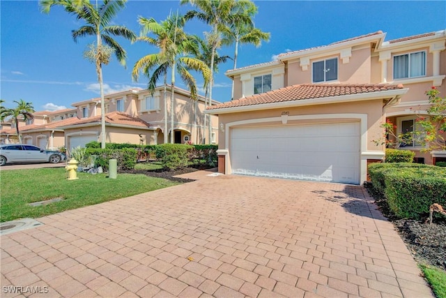 17545 Cherry Ridge Ln, Fort Myers, FL 33967 - view of front facade with a garage, a tiled roof, decorative driveway, and stucco siding