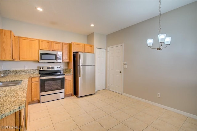 17545 Cherry Ridge Ln, Fort Myers, FL 33967 - kitchen with baseboards, appliances with stainless steel finishes, light stone countertops, a chandelier, and a sink