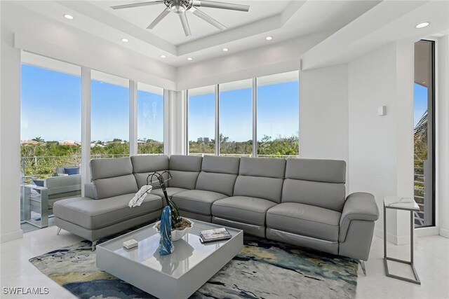 living area with recessed lighting, baseboards, and ceiling fan