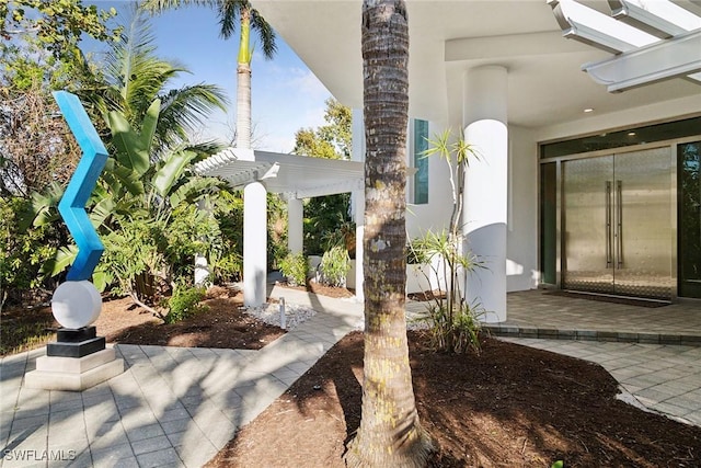 exterior space featuring a patio area, stucco siding, and a pergola