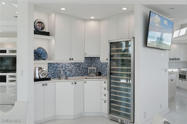 kitchen featuring wine cooler, backsplash, light countertops, and open shelves