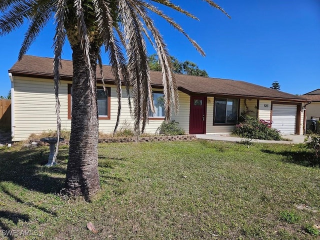 single story home with an attached garage and a front yard