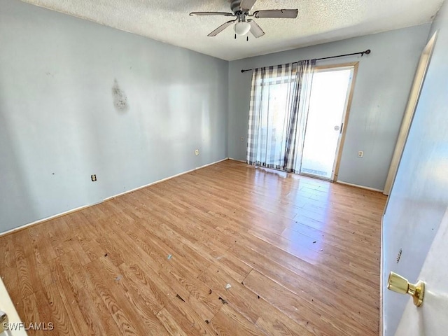 unfurnished room featuring ceiling fan, a textured ceiling, and wood finished floors