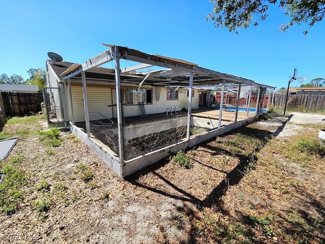 exterior space featuring a patio area, a fenced backyard, and a lanai