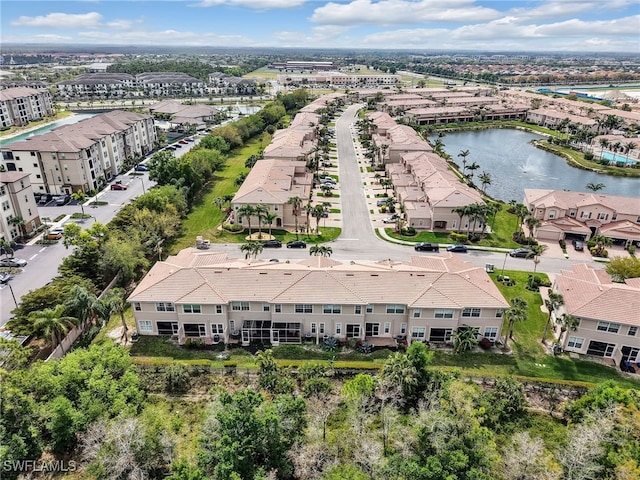 drone / aerial view featuring a residential view and a water view