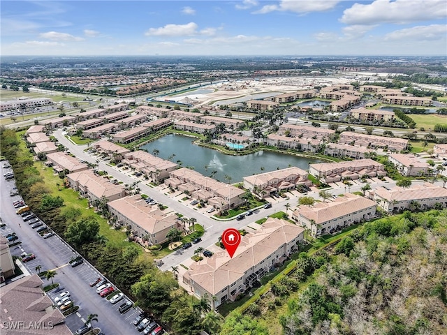 birds eye view of property with a water view and a residential view