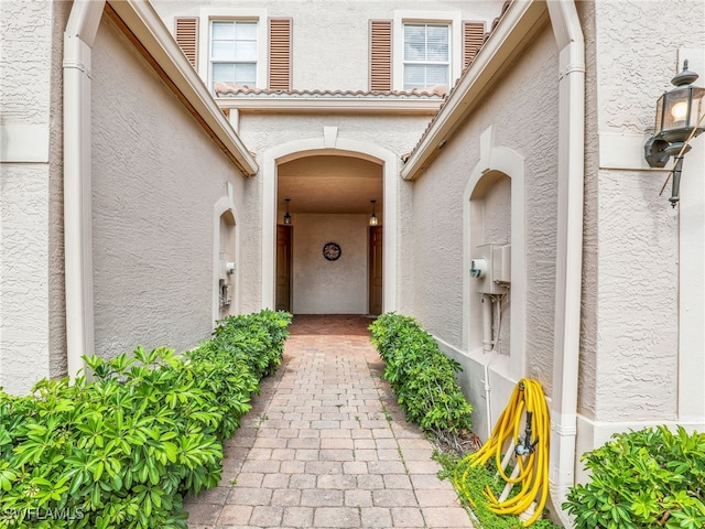 view of exterior entry featuring stucco siding