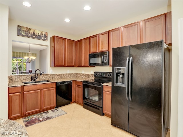 kitchen with light tile patterned floors, recessed lighting, a sink, light stone countertops, and black appliances