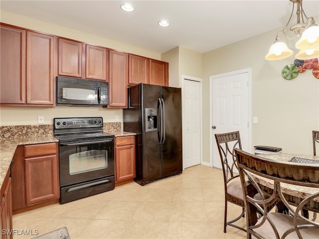 kitchen with light stone counters, recessed lighting, hanging light fixtures, an inviting chandelier, and black appliances