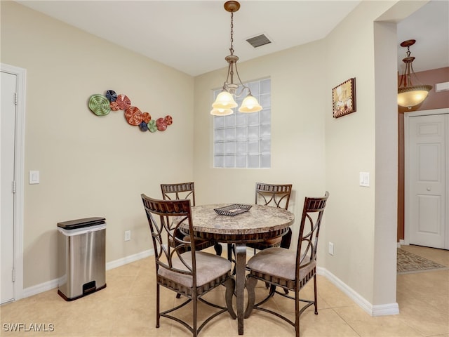 dining room with light tile patterned floors, visible vents, and baseboards