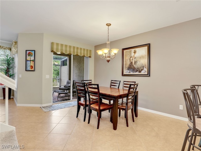 dining space with light tile patterned floors, baseboards, and a chandelier