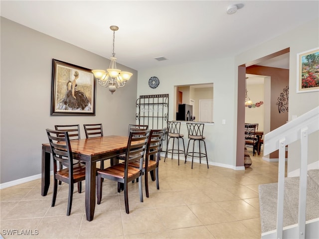 dining space with light tile patterned floors, baseboards, visible vents, stairway, and a notable chandelier