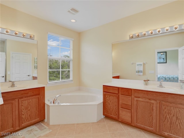 ensuite bathroom with two vanities, ensuite bath, tile patterned flooring, and a sink