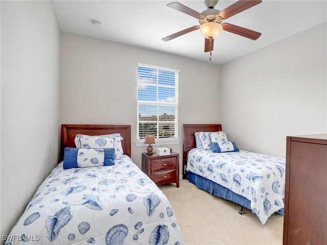 bedroom featuring light carpet and a ceiling fan