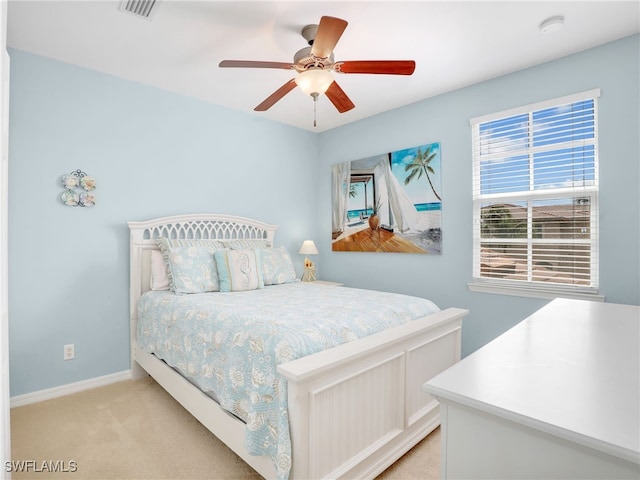 bedroom with light carpet, baseboards, visible vents, and ceiling fan