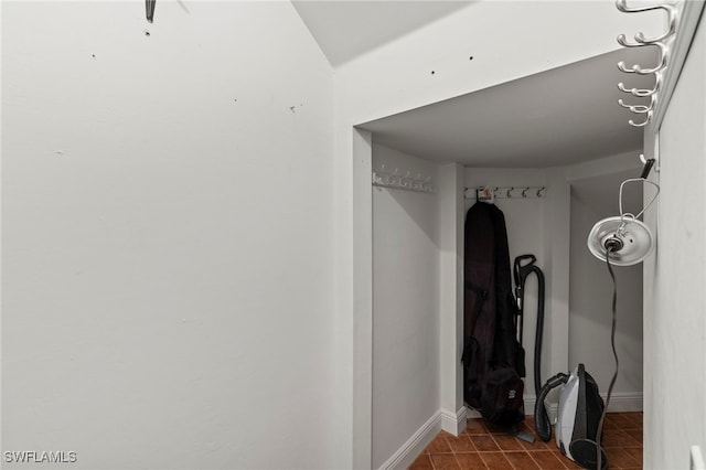 interior space featuring tile patterned floors and baseboards