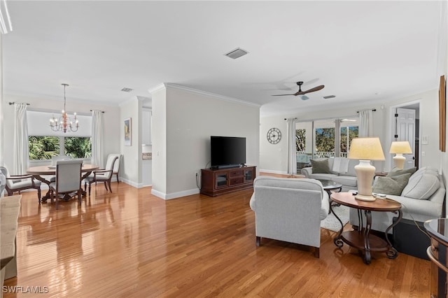 living area with visible vents, light wood-style flooring, ceiling fan with notable chandelier, and baseboards