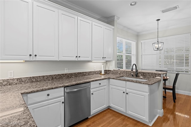 kitchen featuring light wood finished floors, visible vents, stainless steel dishwasher, white cabinets, and a sink