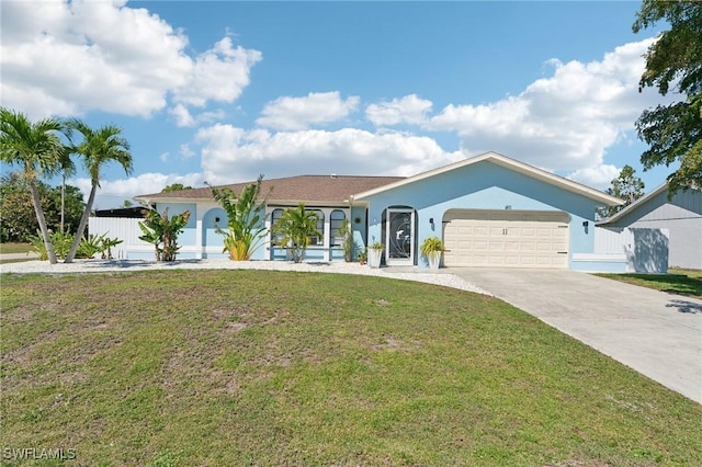 view of front of property with a front yard, fence, driveway, an attached garage, and stucco siding