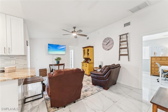 living area with visible vents, marble finish floor, and ceiling fan