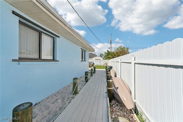 view of property exterior with stucco siding and a fenced backyard