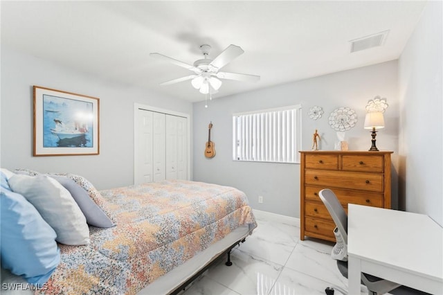 bedroom with visible vents, marble finish floor, a closet, baseboards, and ceiling fan