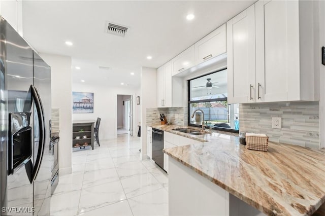 kitchen featuring visible vents, a sink, black dishwasher, marble finish floor, and stainless steel fridge