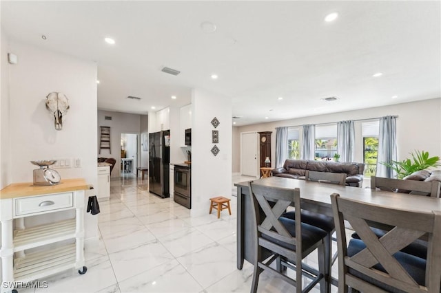 dining room with recessed lighting, visible vents, and marble finish floor