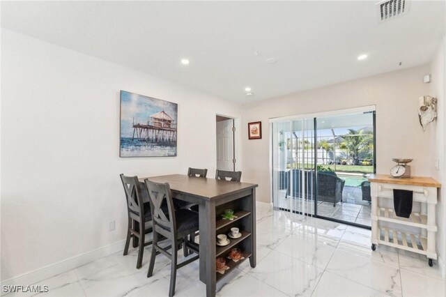 401 SE 14th Ter, Cape Coral, FL 33990 - dining room featuring light marble finish floors and recessed lighting