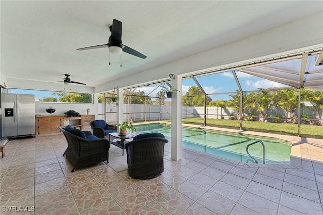 view of pool featuring glass enclosure, a fenced in pool, an outdoor kitchen, a fenced backyard, and a patio area