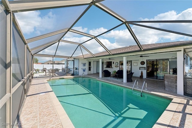 pool with a lanai, ceiling fan, and a patio area