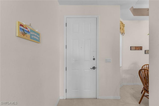 interior space featuring light tile patterned floors and baseboards