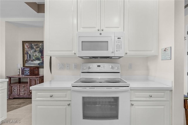 kitchen featuring white cabinetry, white appliances, and light countertops