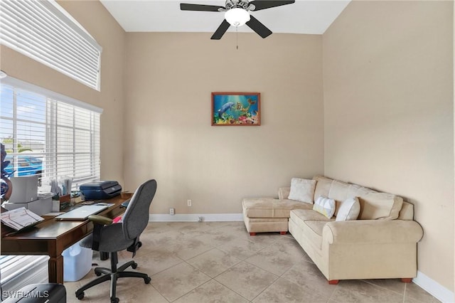 office space featuring light tile patterned floors, baseboards, and a ceiling fan