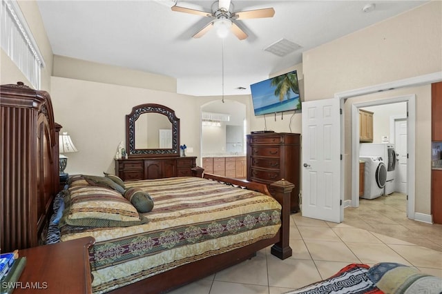 bedroom with a ceiling fan, light tile patterned floors, washing machine and dryer, and visible vents