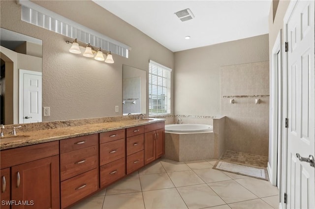 full bath featuring double vanity, a walk in shower, a garden tub, and a sink