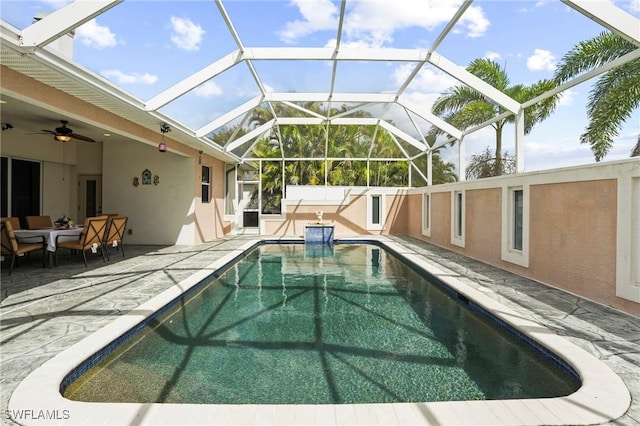 outdoor pool featuring a lanai, a ceiling fan, and a patio