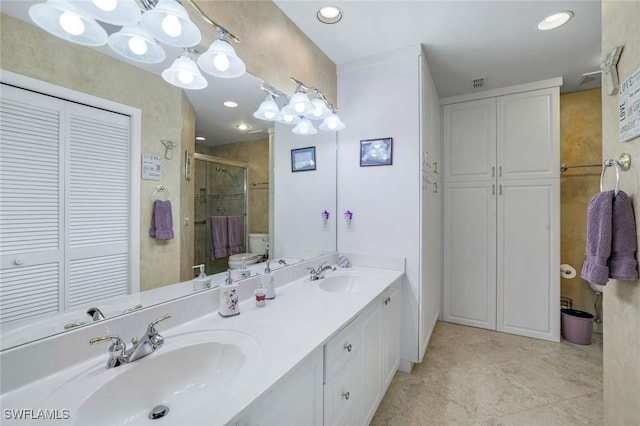 full bathroom with a sink, a shower stall, visible vents, and a closet