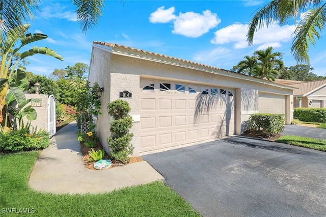 garage with aphalt driveway