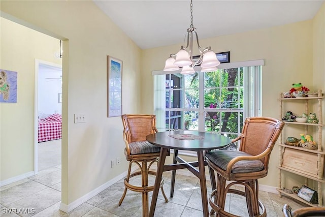 dining room with a chandelier, baseboards, and light tile patterned flooring
