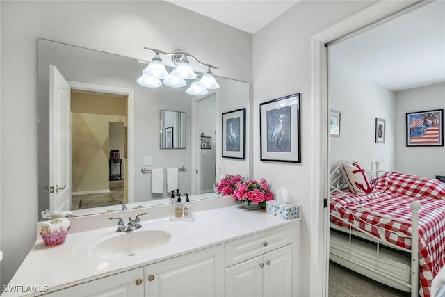 bathroom with connected bathroom, vanity, and a chandelier