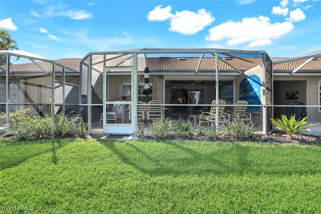 back of house with a yard, a tile roof, and glass enclosure