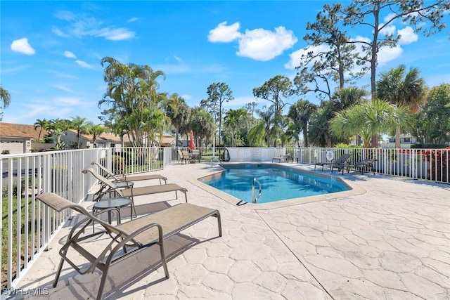 pool featuring a patio and fence