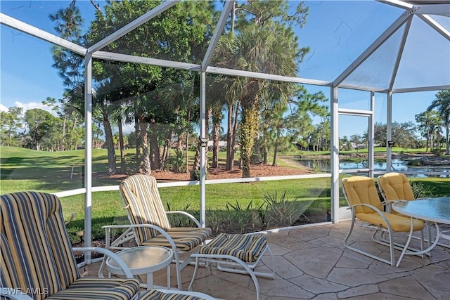 sunroom / solarium featuring a water view